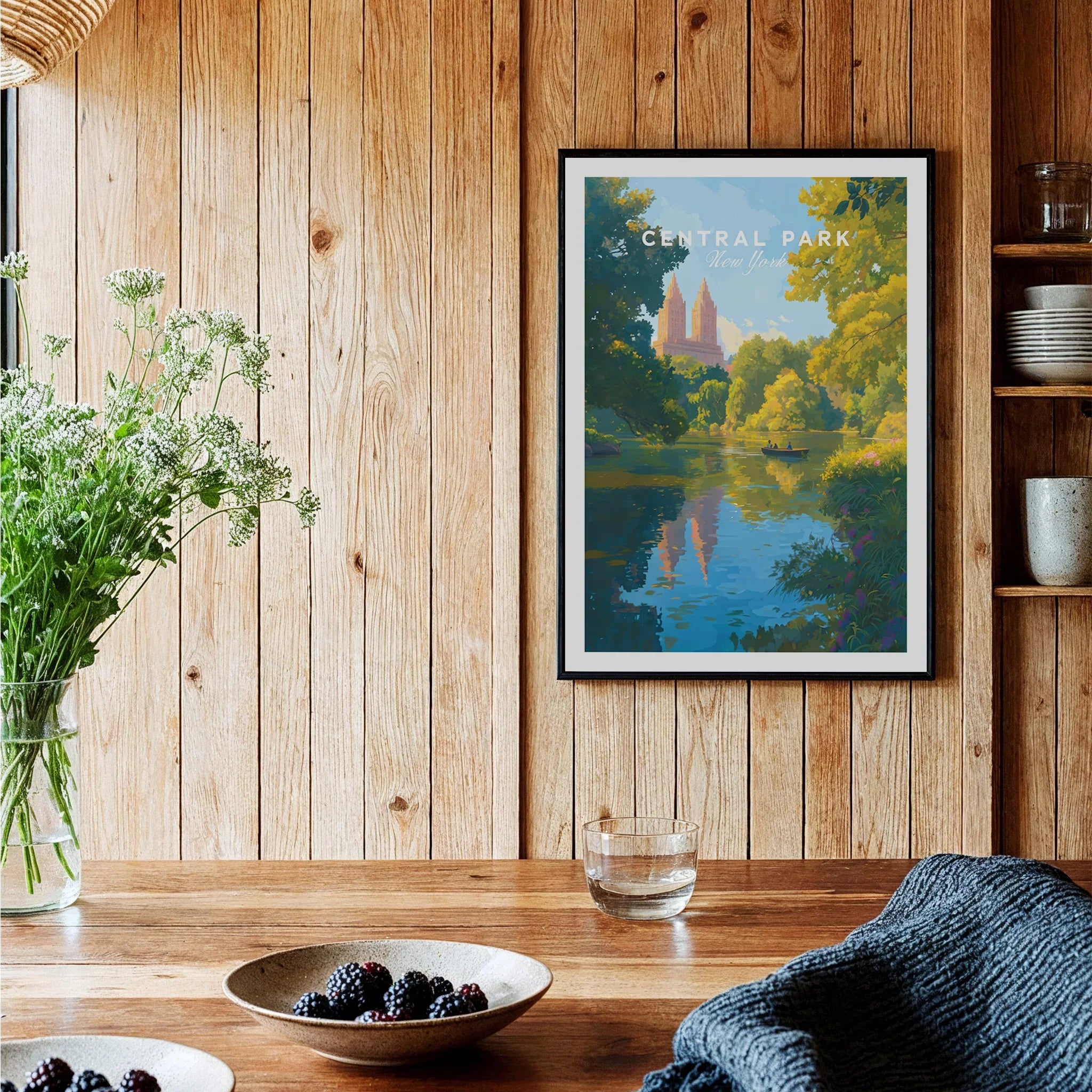 Central Park art print with lake and skyline in black frame, displayed in rustic kitchen