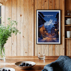 Chamonix Poster framed on a wooden wall, featuring a snowy evening scene in Chamonix, perfect for home decor.