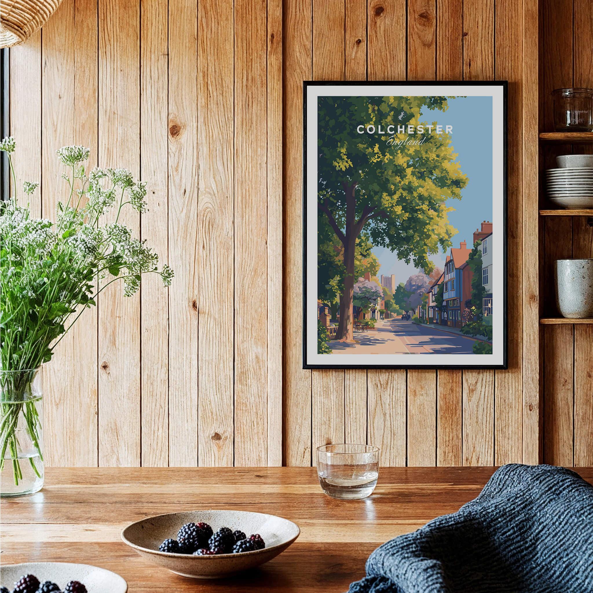 Colchester travel poster art print in black frame hung on wood wall in cozy kitchen decor