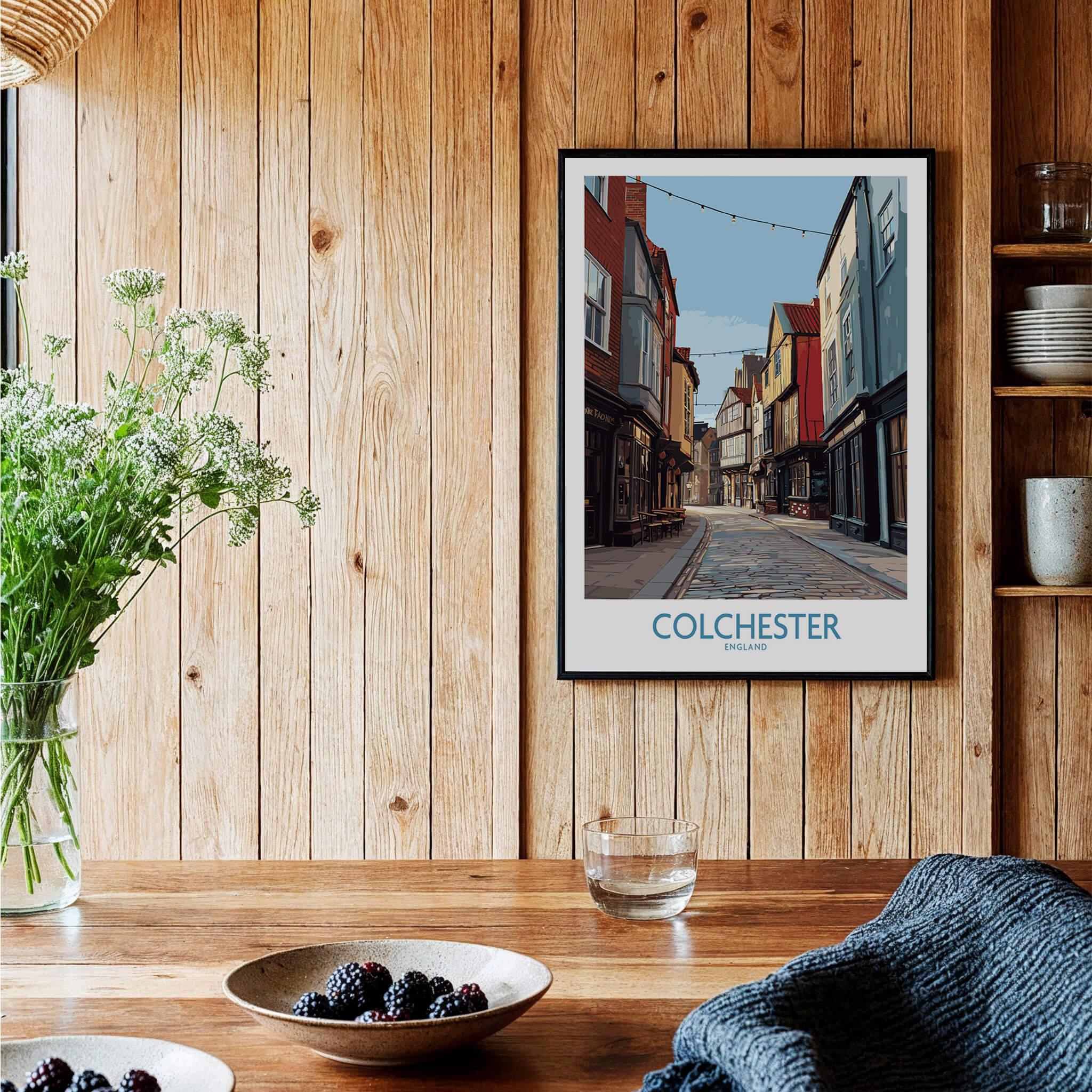 Colchester travel poster art print in black frame on rustic kitchen wall with wooden panels