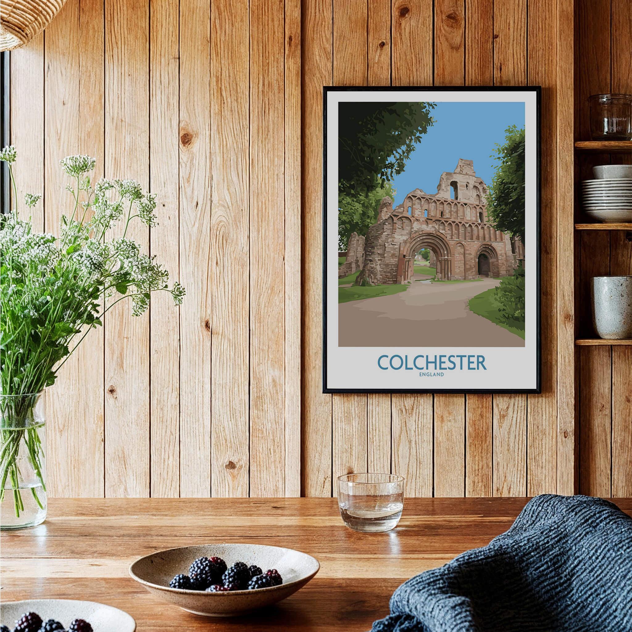 Colchester travel poster with historic stone archway, framed and hung in a rustic kitchen setting.