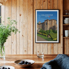 Framed Colchester England travel poster on wooden kitchen wall, rustic home decor.