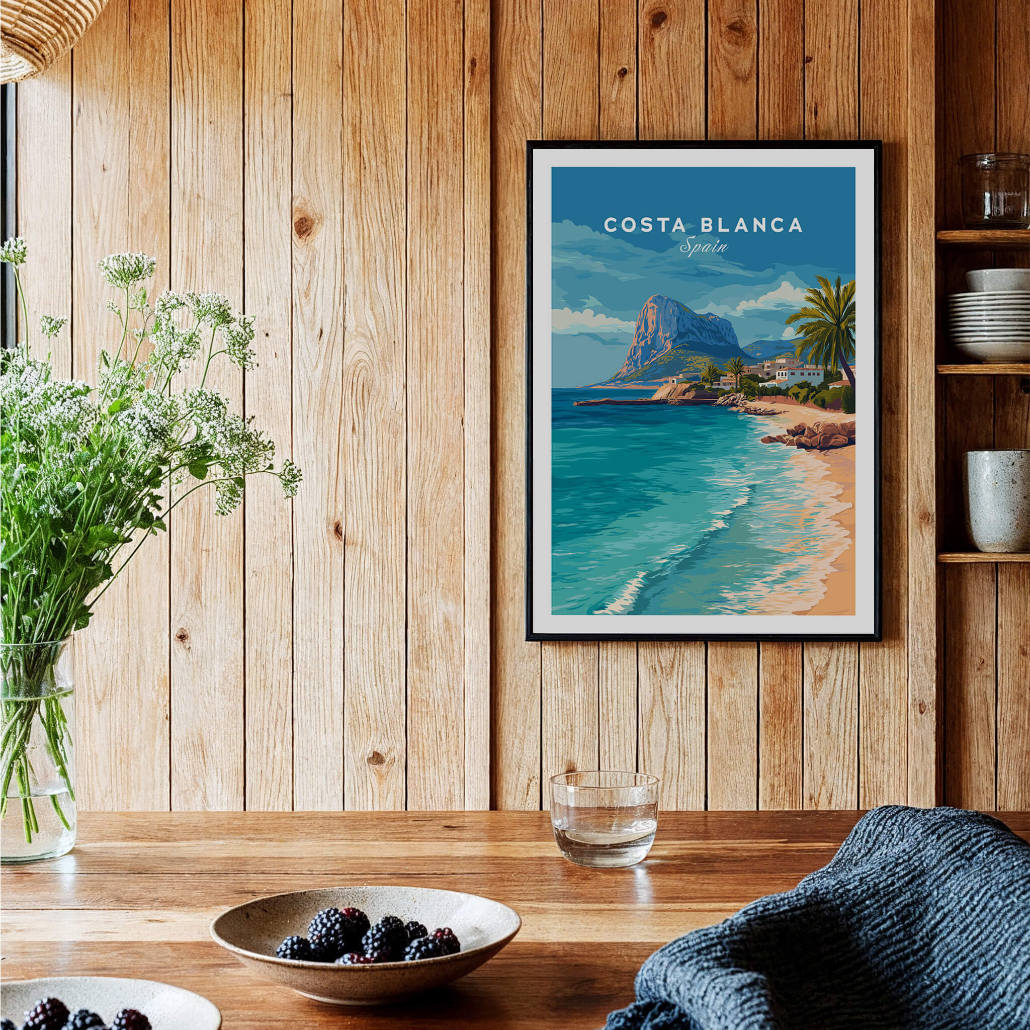 Costa Blanca Spain Travel Art – Mediterranean Village & Turquoise Sea Landscape Poster displayed in a rustic interior.