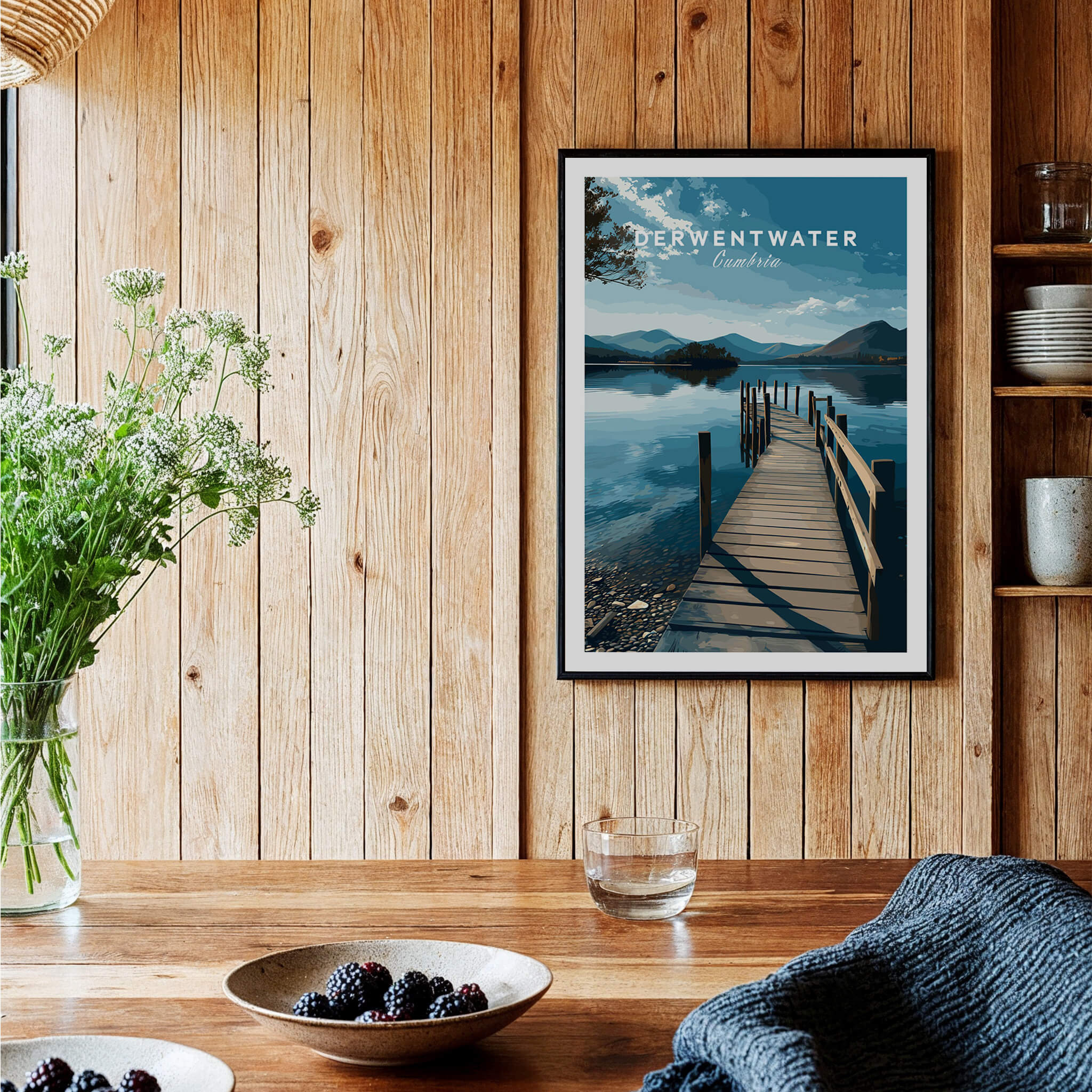 Derwentwater Travel Poster – Lake District Canvas Print displayed on a wooden wall with flowers and table settings.