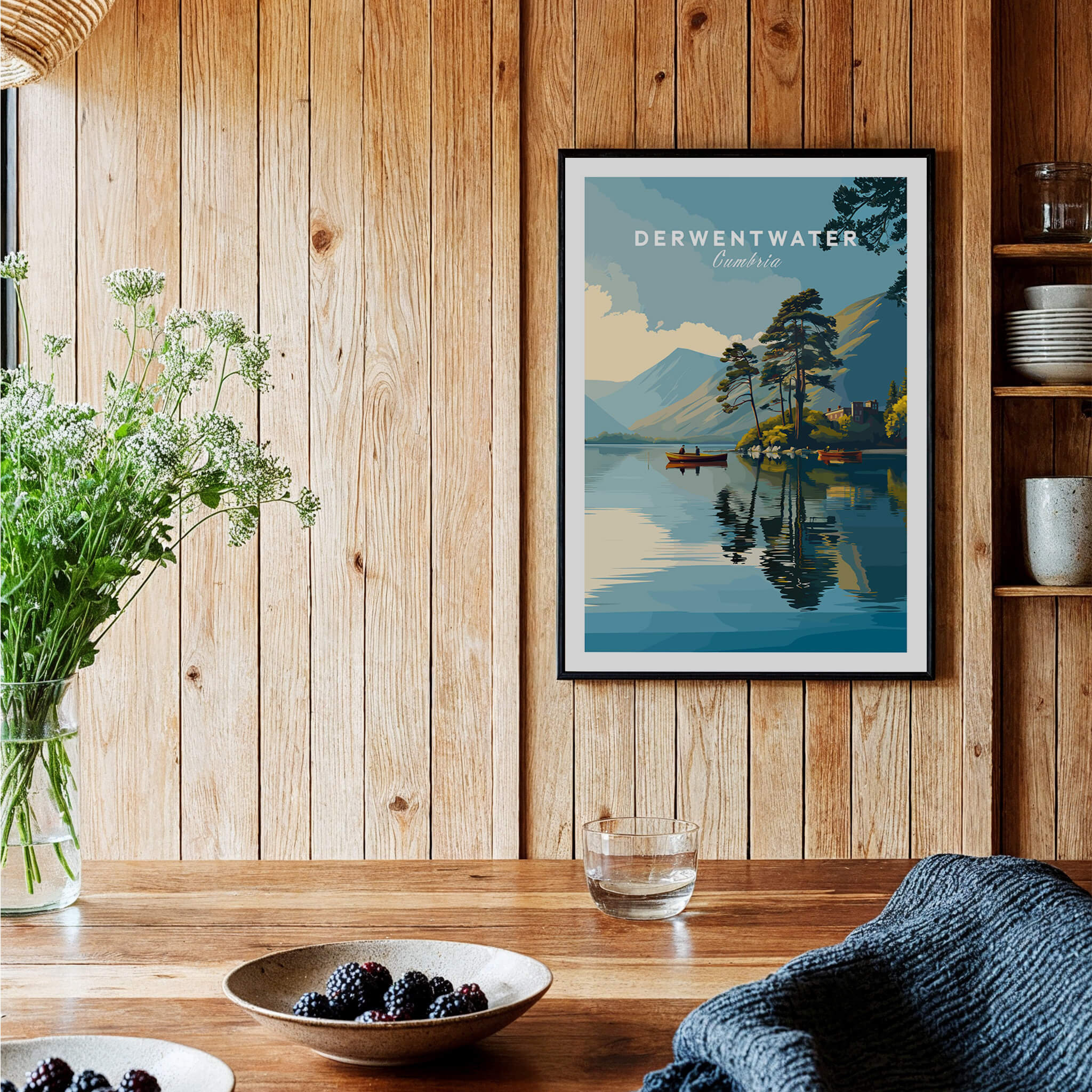 Derwentwater Print – Lake District Sunset Poster displayed in a rustic wooden setting with flowers and tableware.