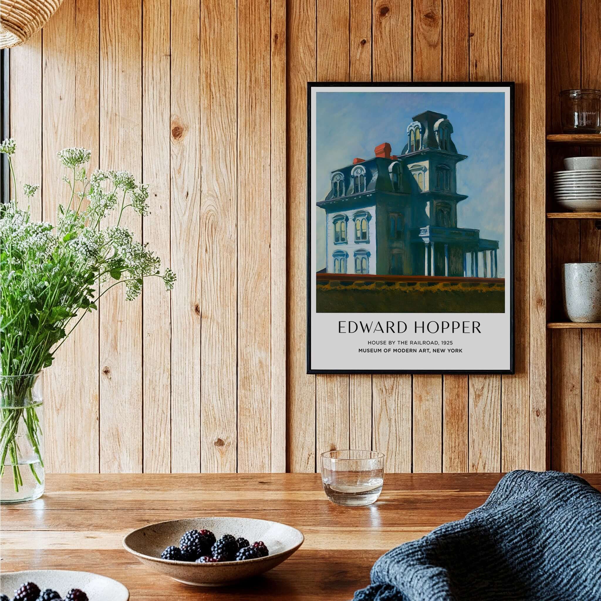 Edward Hopper House by the Railroad 1925 MoMA Art Print Poster displayed in a cozy wooden interior with decor.