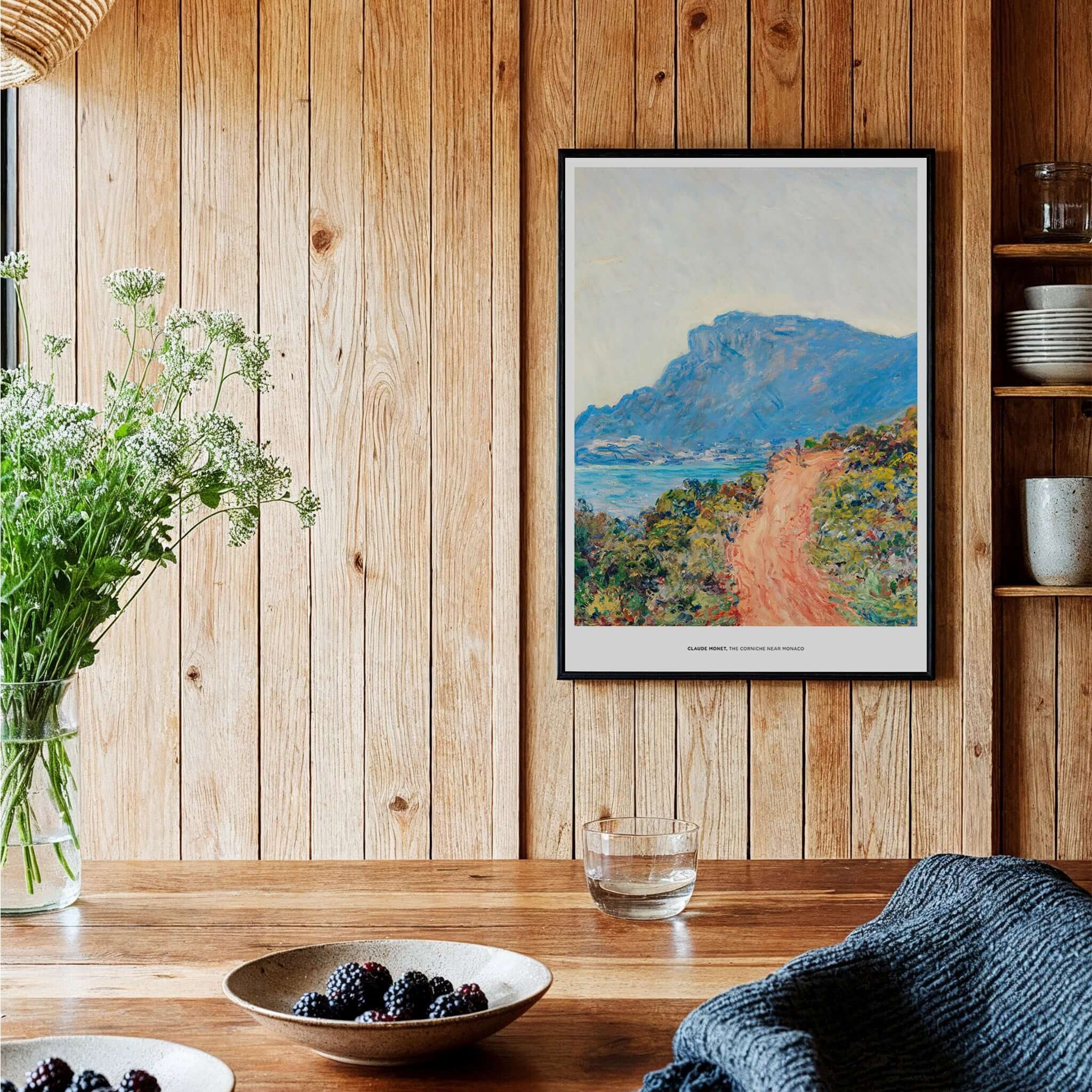 Exhibition Art Print Claude Monet The Corniche near Monaco Impressionist Landscape Poster displayed in a cozy kitchen setting.