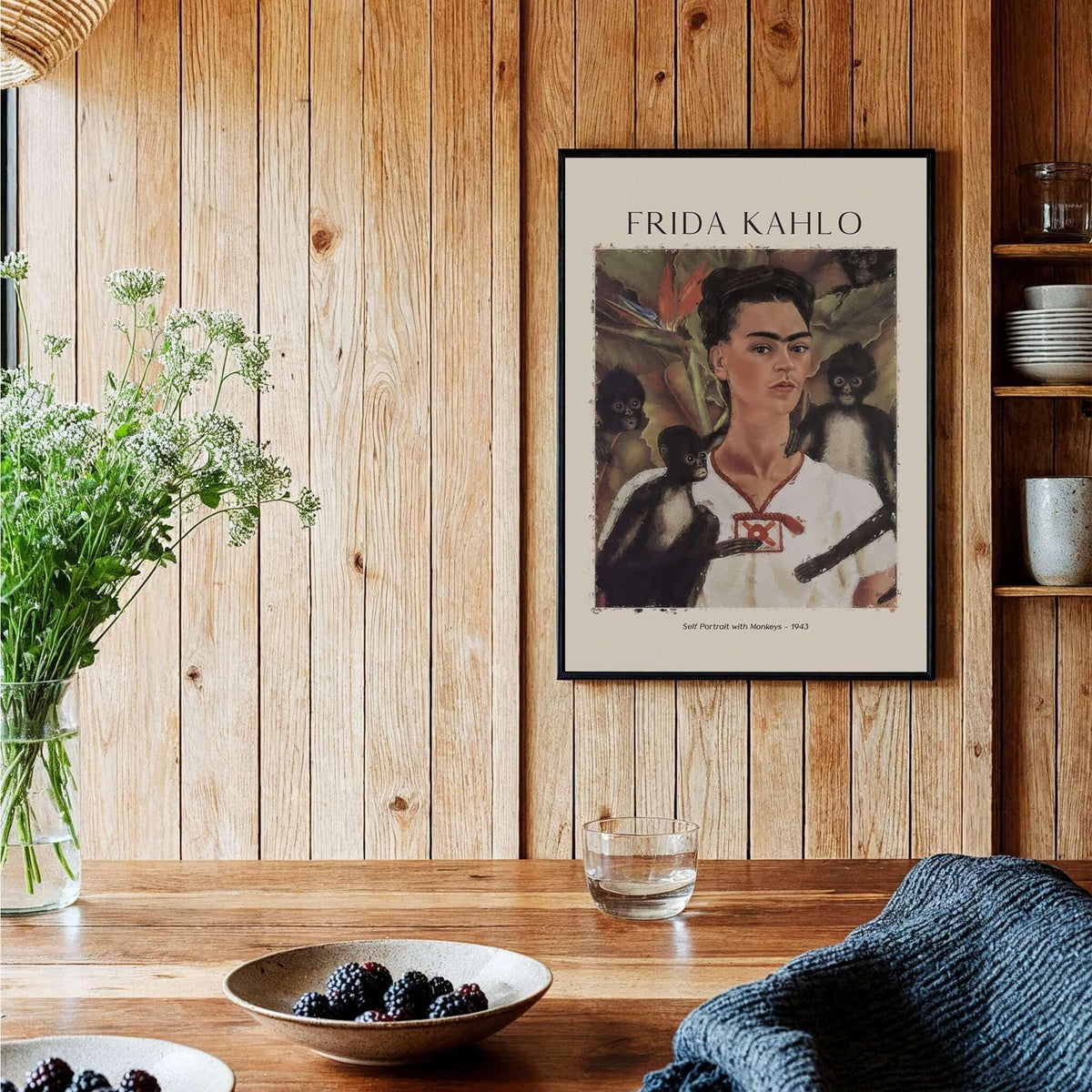 Frida Kahlo Self Portrait with Monkeys Famous Painting Poster Art Print displayed on wooden wall with plants and decor.