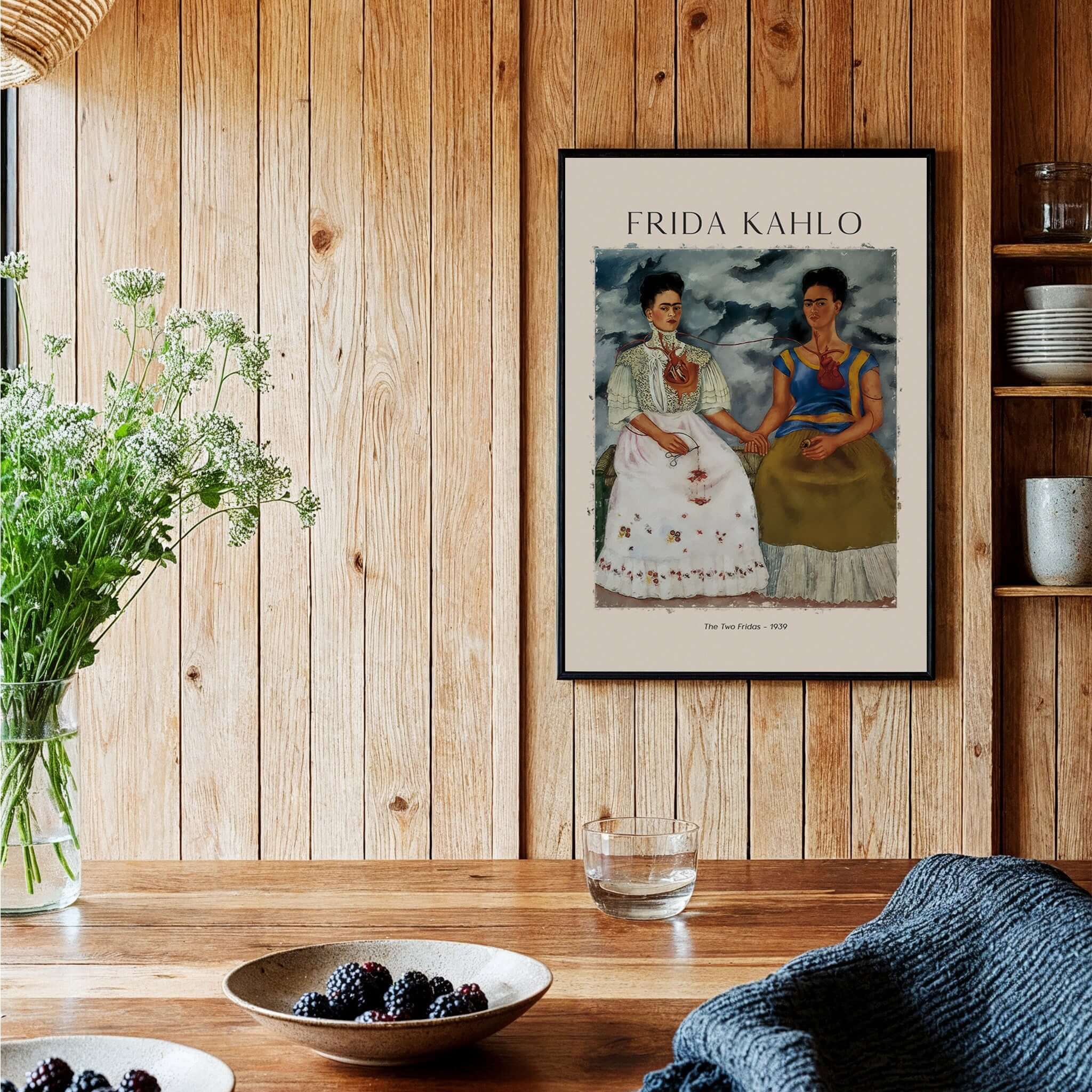 Frida Kahlo The Two Fridas Famous Art Print Poster Wall Art displayed in a wooden interior with a vase and table.