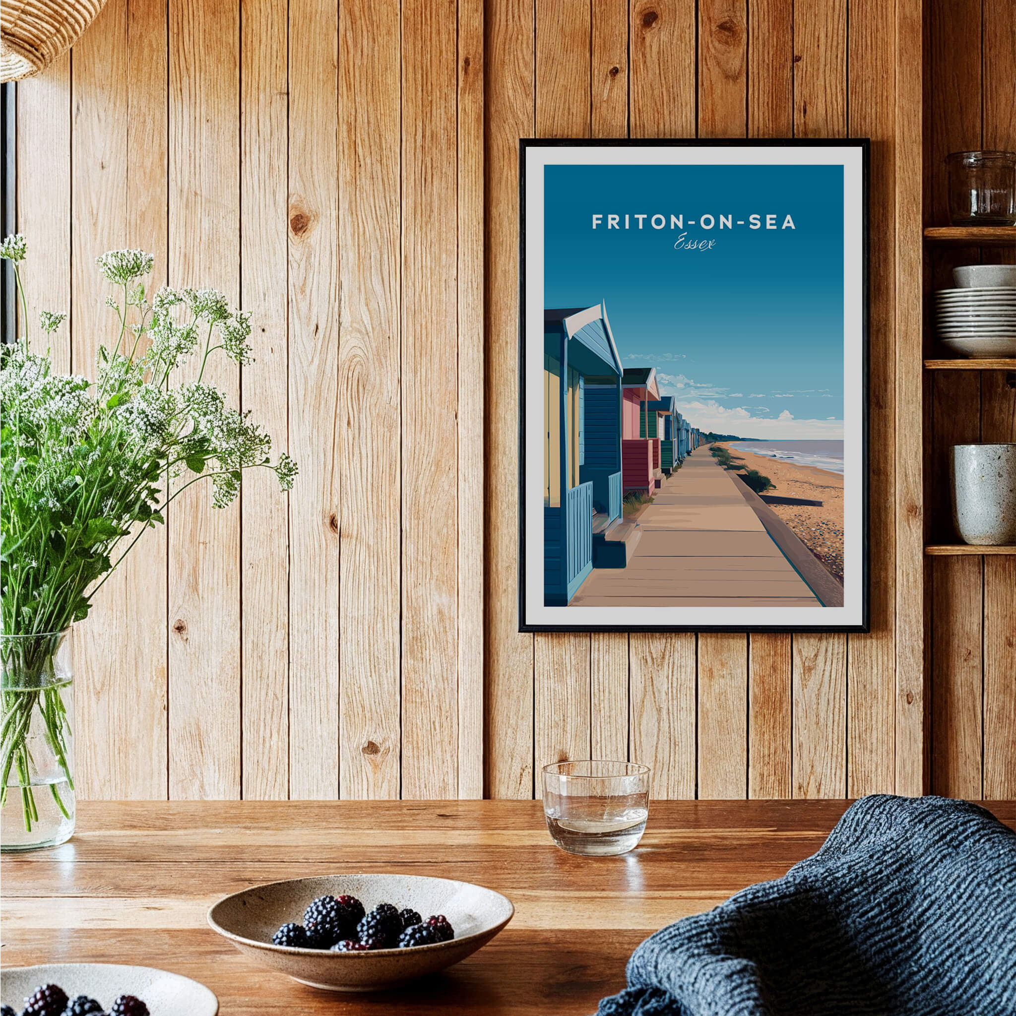 Frinton-on-Sea Travel Poster – Essex Coastline Beach Huts & Prom Art displayed in a cozy interior with wooden accents.