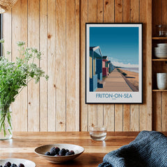 Frinton-on-Sea England Wall Art – Colorful Seaside Beach Hut Decor Print displayed in a rustic wooden setting.