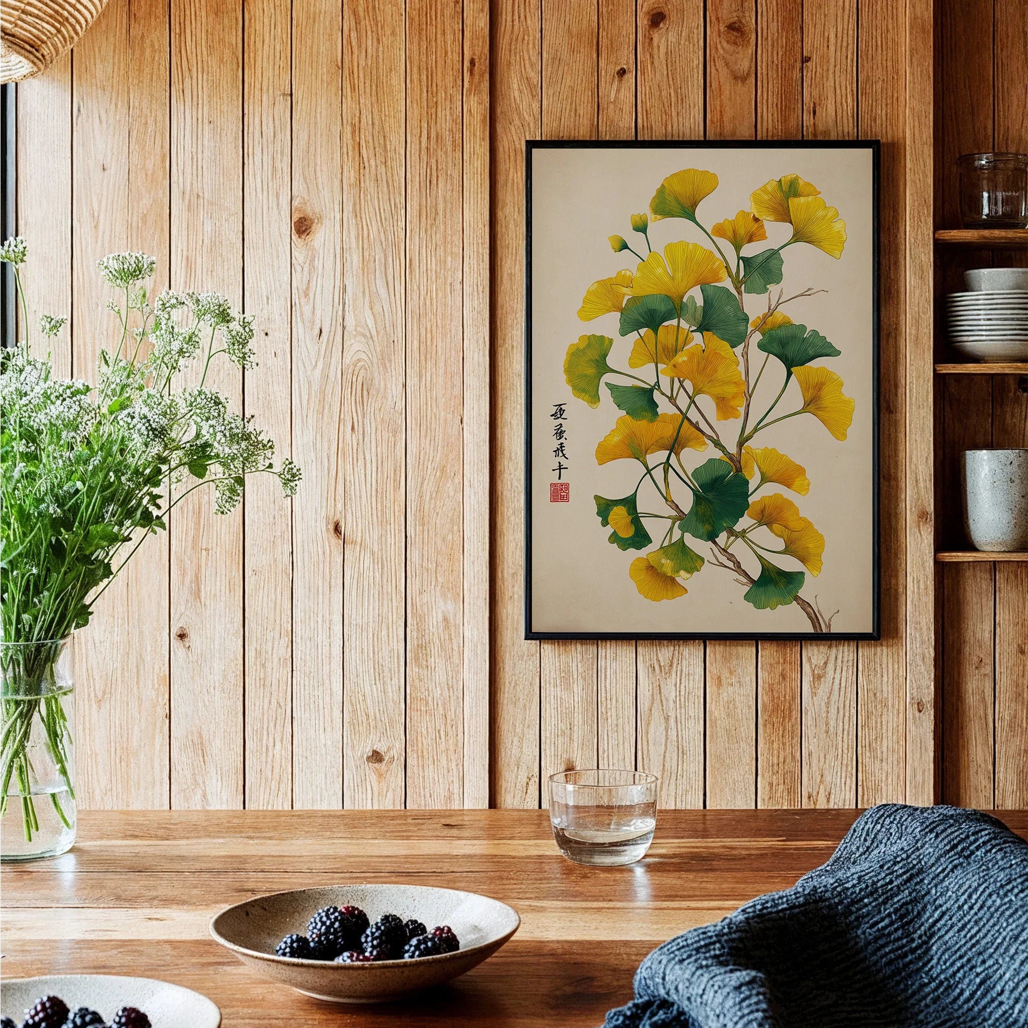 Ginkgo botanical art print with black frame on wood wall in cozy kitchen setting
