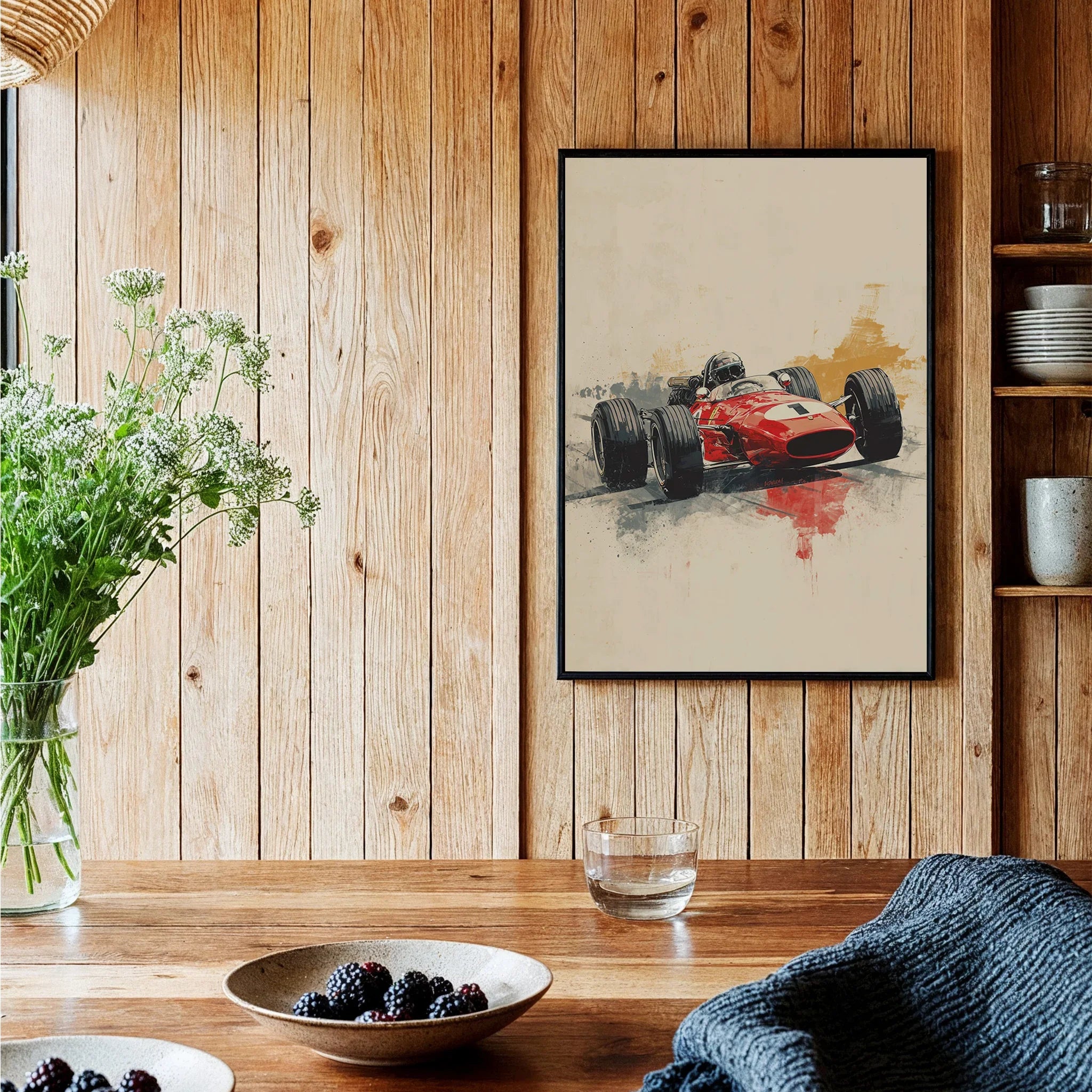 Framed art print of a vintage red race car hung in a rustic kitchen setting with wood walls.