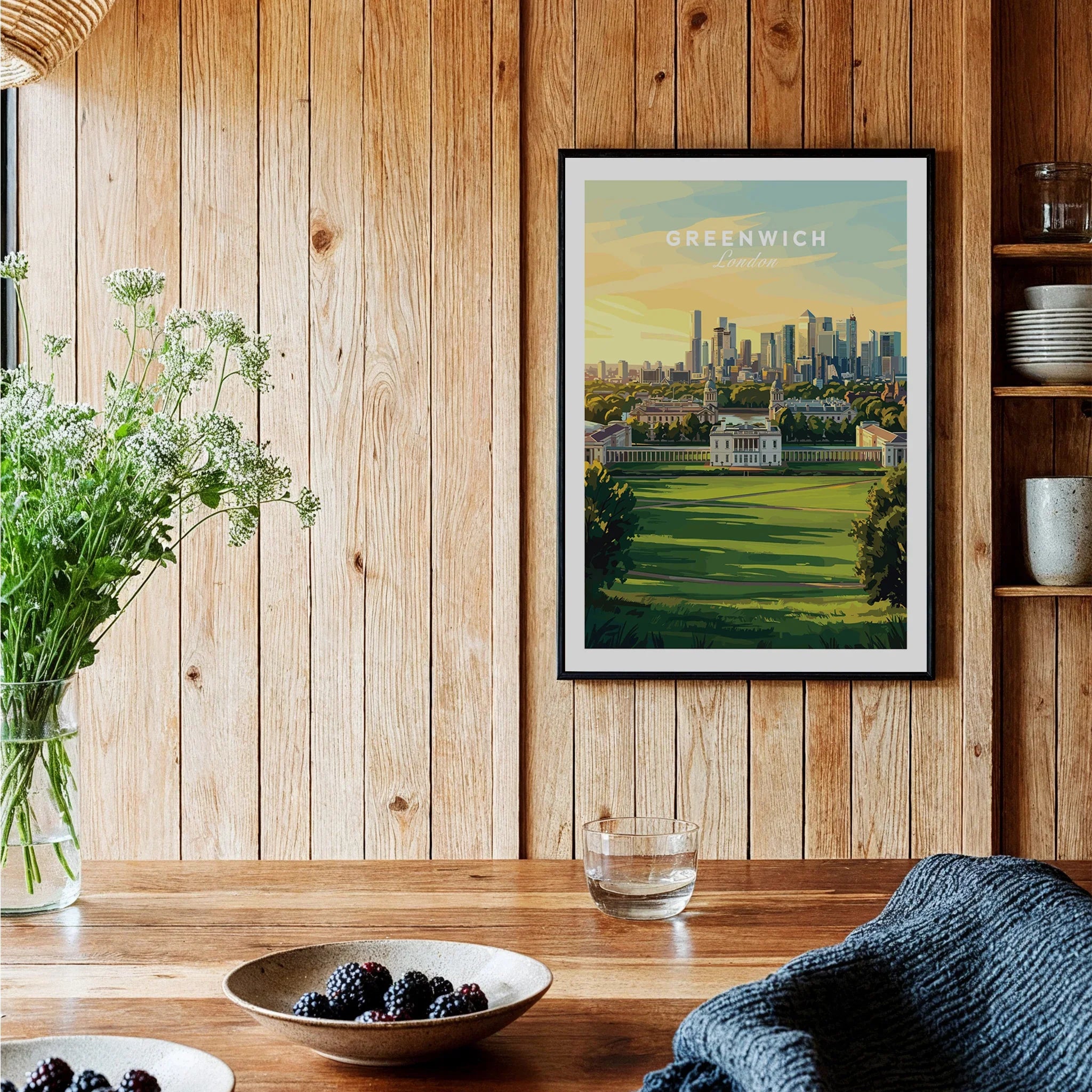 Greenwich London skyline art print in black frame, displayed above rustic kitchen table