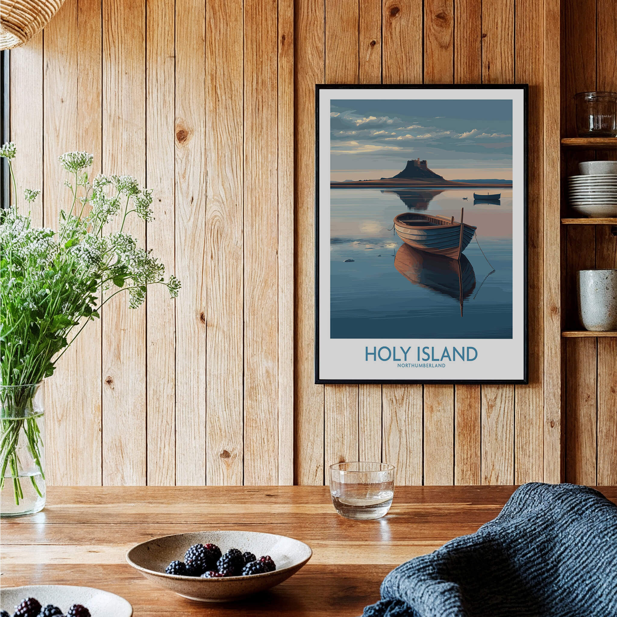 Holy Island Poster Northumberland | Lindisfarne Canvas Print displayed in a cozy interior with a wooden table.
