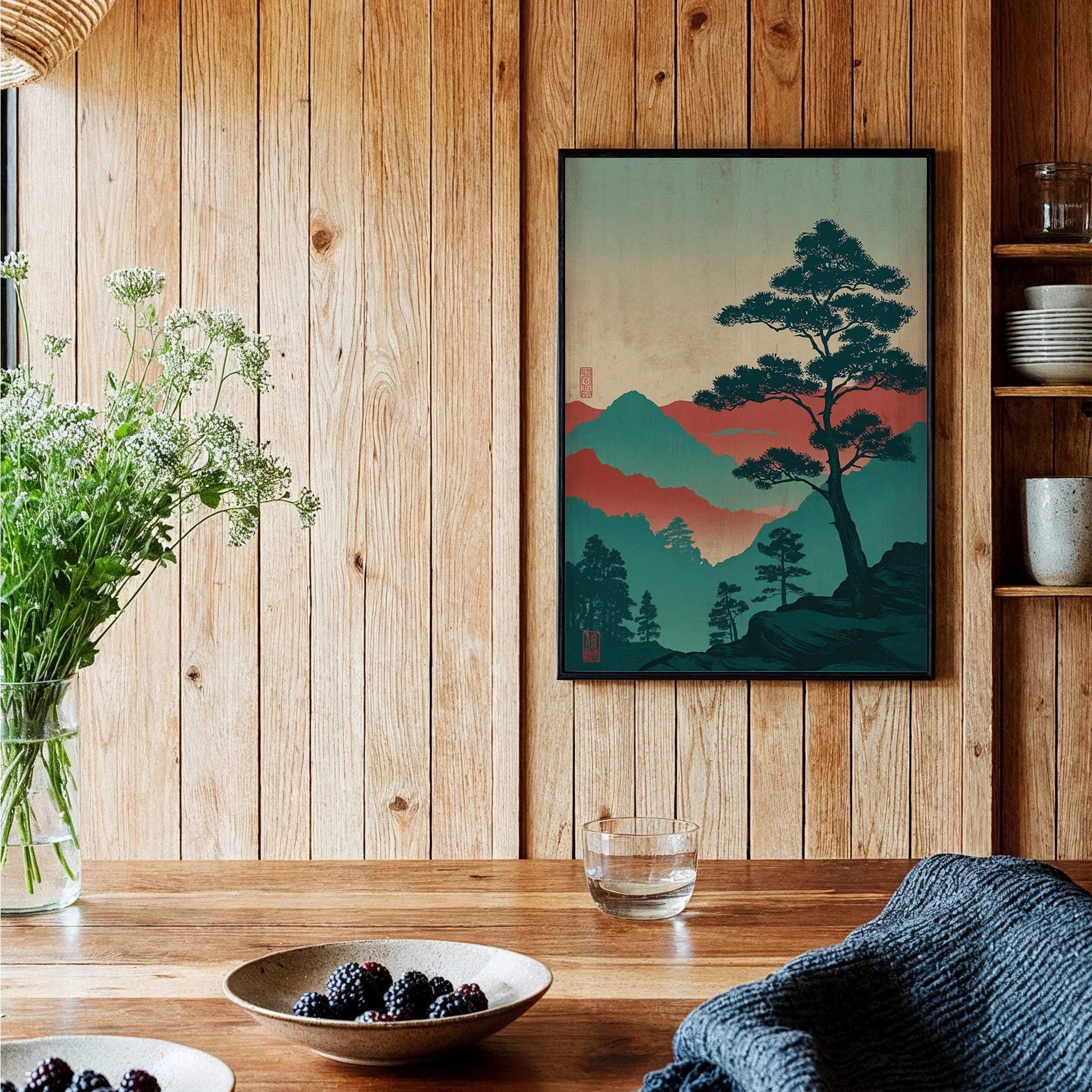 Framed Japanese woodblock-style art print of colorful mountains and trees in a cozy kitchen.