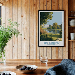 Kew Gardens travel poster print in black frame, displayed in rustic kitchen setting