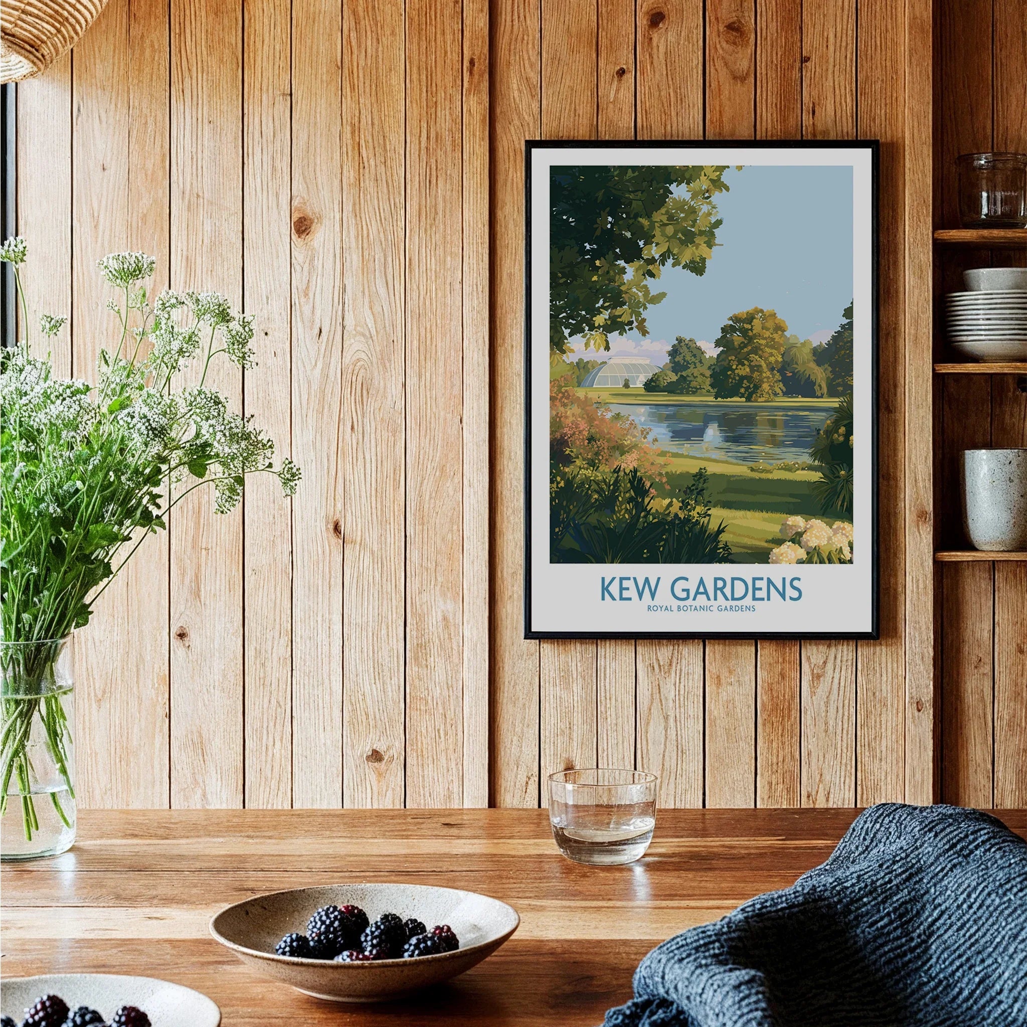 Kew Gardens travel poster print in black frame, displayed in rustic kitchen setting