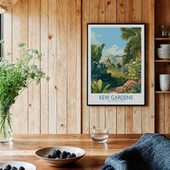 Framed Kew Gardens travel poster on wooden kitchen wall above rustic table with flowers and berries