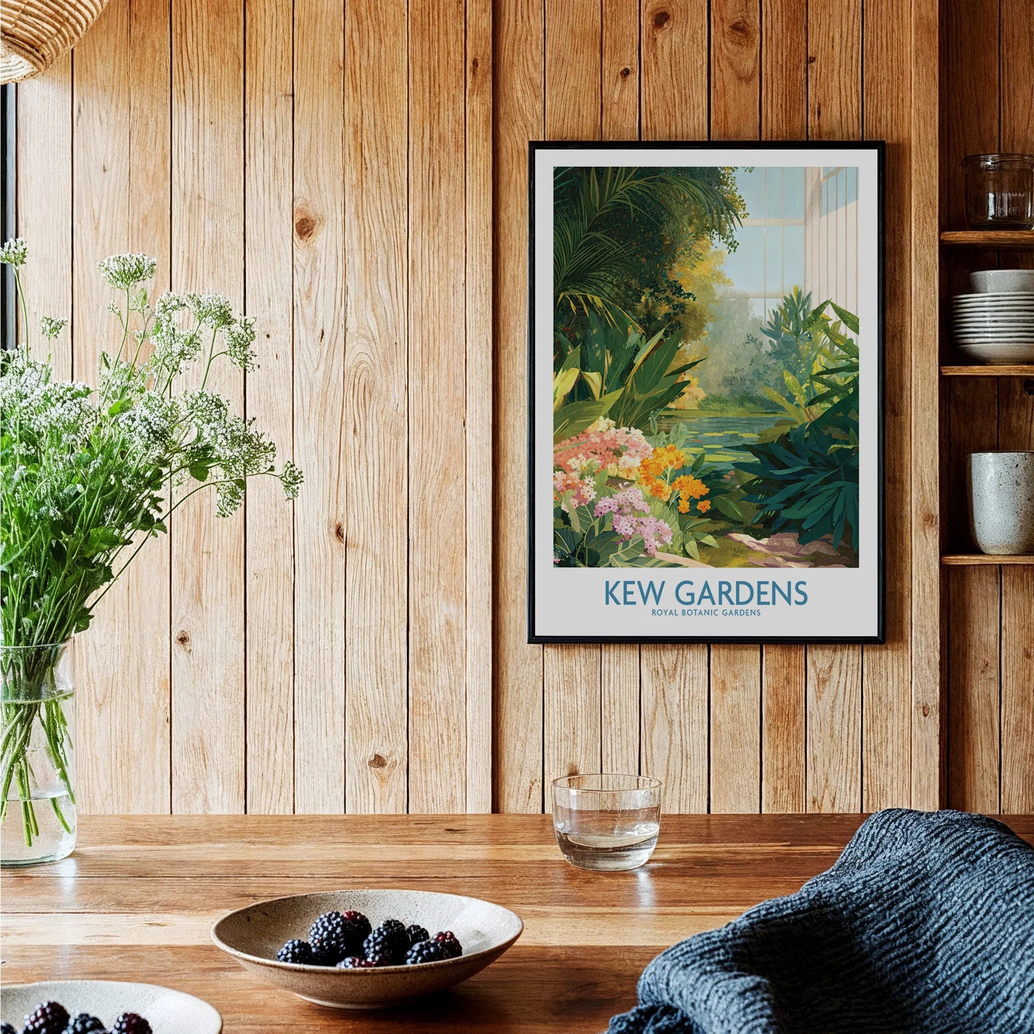 Kew Gardens art print with botanical illustration in black frame on wood kitchen wall.