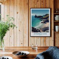 Kynance Cove Cornwall Poster | Scenic Sea Cliffs & Beach Canvas Print displayed in a cozy wooden setting with flowers.