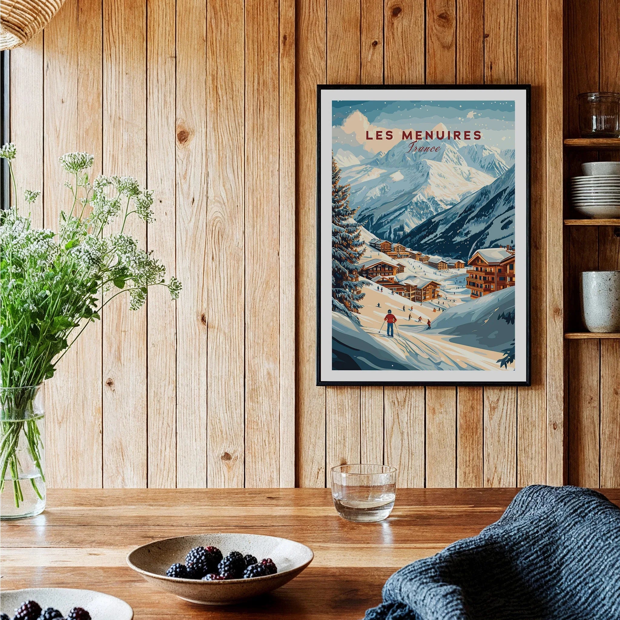 Framed Les Menuires France travel art print in rustic kitchen with wood panel walls