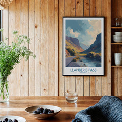 Llanberis Pass framed travel print on wood wall in rustic kitchen setting with berries and flowers