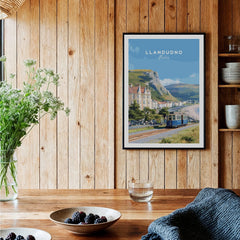 Llandudno Wales travel poster art print in black frame displayed in rustic kitchen setting