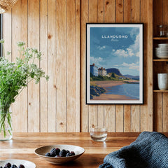 Llandudno Wales travel poster in black frame on wood wall in cozy kitchen setting