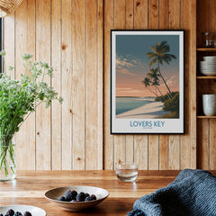 Lovers Key Canvas Print | Florida Gulf Coast Beach Poster displayed on a wooden wall near plants and dishes.