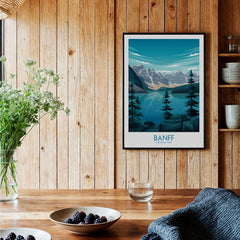Framed Banff National Park travel poster in a rustic kitchen with wood walls and decor