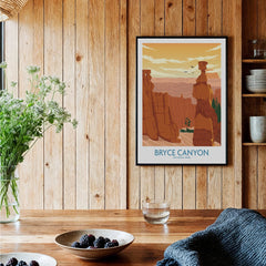 Bryce Canyon National Park art print in black frame hanging in a rustic wood kitchen setting.