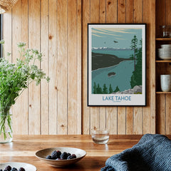 Lake Tahoe travel poster art print in black frame on wood wall in cozy kitchen setting
