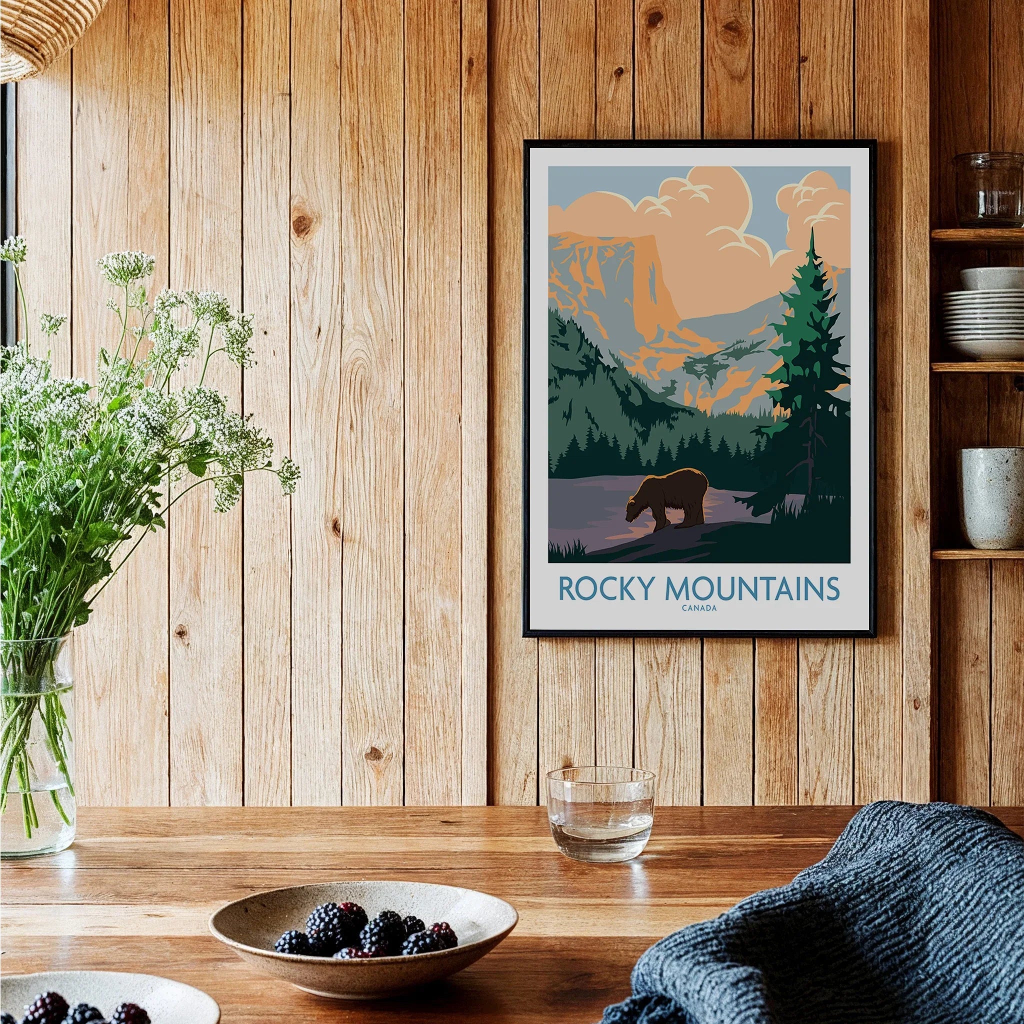 Framed Rocky Mountains Canada art print with bear in rustic kitchen setting