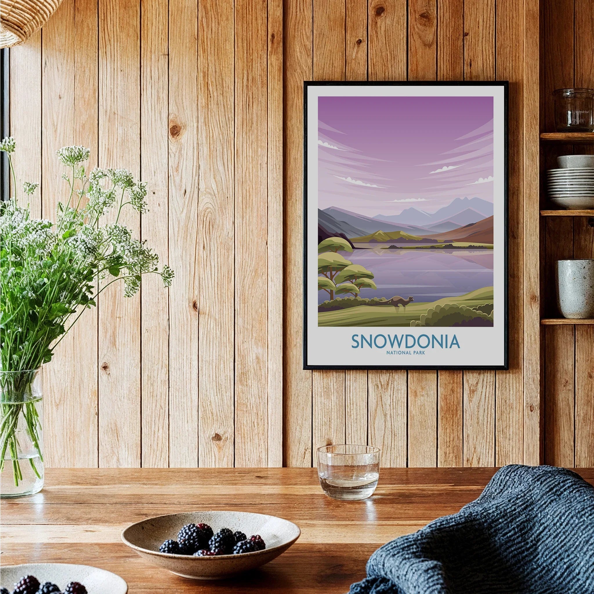 Snowdonia National Park art print with mountains and lake, framed on a rustic kitchen wall