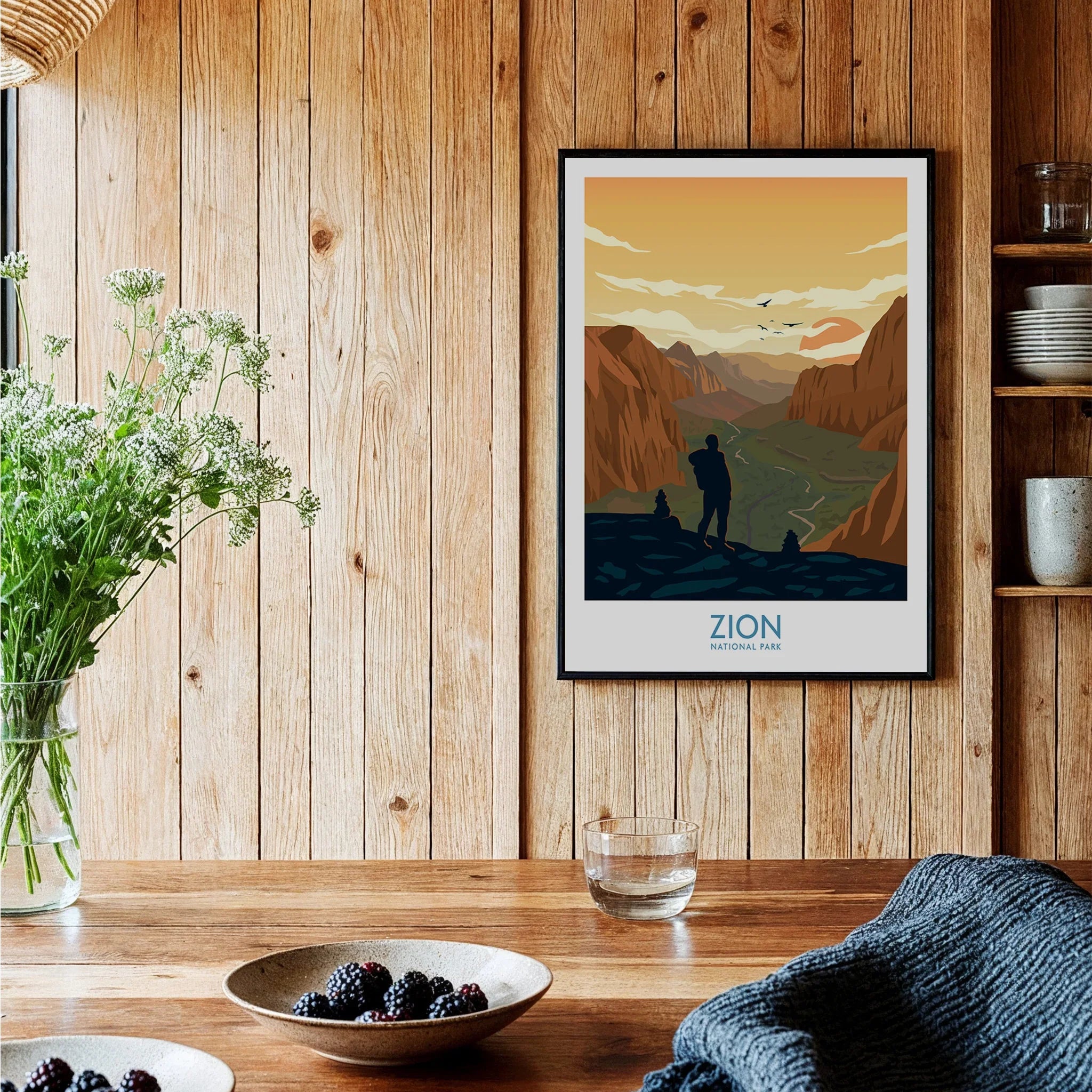 Framed Zion National Park art print on wood wall in rustic kitchen with bowls of berries