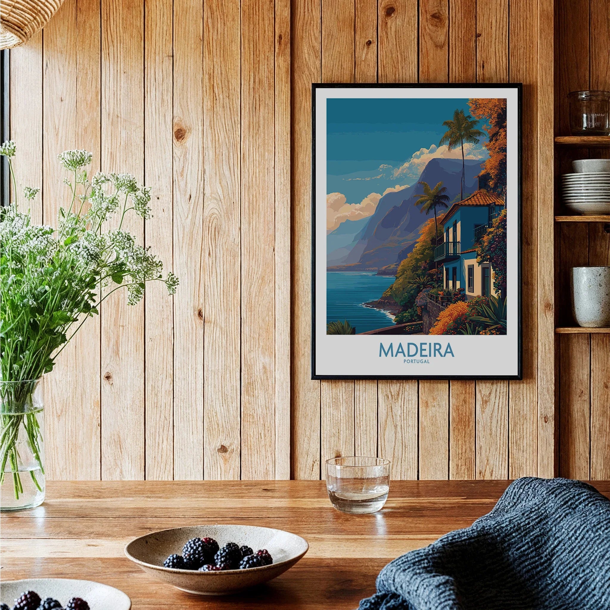 Madeira travel poster with coastal landscape framed on wood wall in cozy kitchen setting