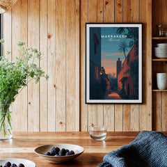 Marrakesh Morocco Travel Poster | Medina Alleyway Twilight Wall Art Print displayed on a wooden wall with a plant.