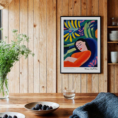 Matisse Art Prints - Abstract Woman in Foliage Poster displayed on wooden wall with vibrant colors and serene atmosphere.