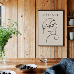 Matisse Art Prints - Continuous Line Abstract Face Poster showcased in a wooden kitchen setting.