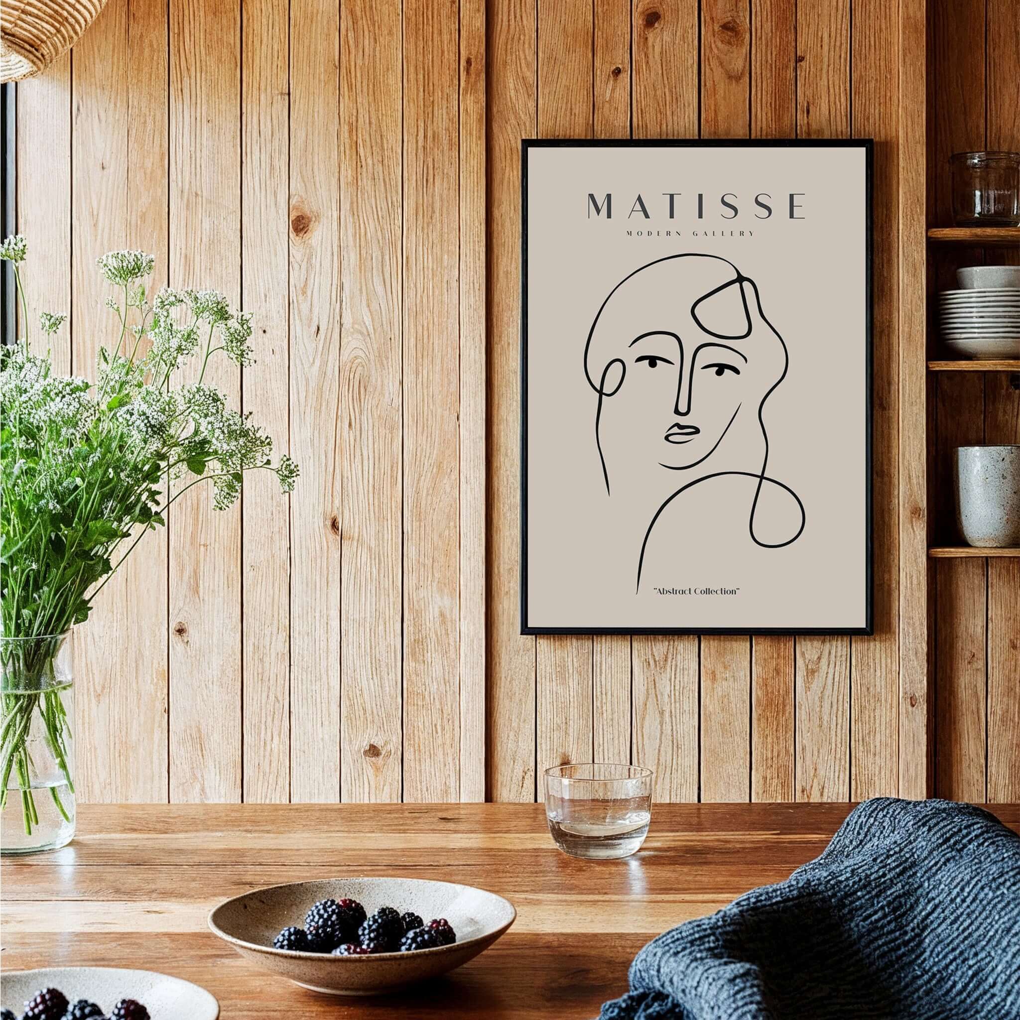 Matisse Art Prints - Continuous Line Abstract Face Poster showcased in a wooden kitchen setting.