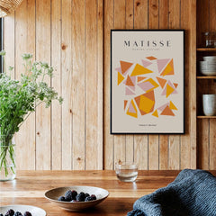 Matisse Art Prints - Warm Tone Geometric Triangles Poster displayed in a cozy kitchen setting with wooden walls.