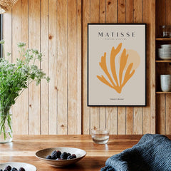 Matisse Art Prints - Orange Seaweed Abstract Art Print displayed in a stylish interior with wooden walls and vibrant decor.