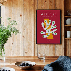 Matisse Art Prints - White Coral Abstract Green Diamonds Print displayed on a wooden wall with green plants and bowls.