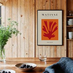 Matisse Art Prints - Red Leaf Abstract Orange Square Poster displayed in a cozy wooden interior with greenery.