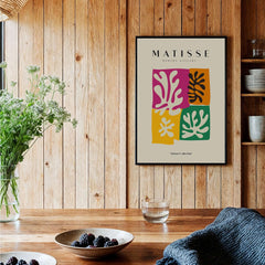 Matisse Art Prints - Four Block Abstract Leaves Poster displayed in a cozy interior with wooden walls and a plant.