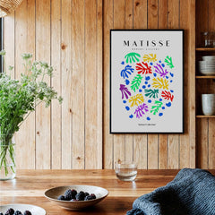 Matisse Art Prints - Colourful Scattered Abstract Leaves Dots Poster displayed in a rustic setting with plants and dishes.