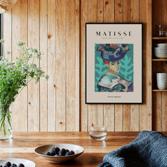 Matisse Art Prints - Woman Large Hat Portrait Teal Background Poster displayed in a cozy interior setting.