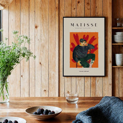 Matisse Art Prints - Seated Figure in Cap Poster displayed in a cozy interior with wooden walls and fresh flowers.