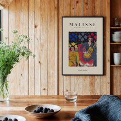 Matisse Art Prints - Two Women Guitar Interior Scene Poster displayed in a cozy interior with wooden accents.